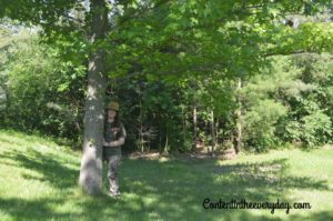 Girl standing in wooded area